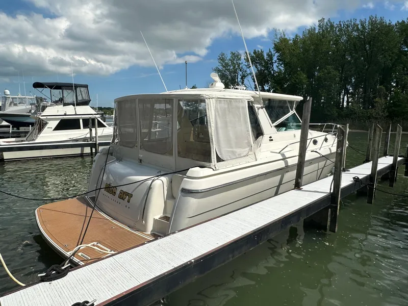 Slide: The Image of 1998 Tiara Yachts 4000 Express docked, featuring a sleek design and spacious deck. - 8