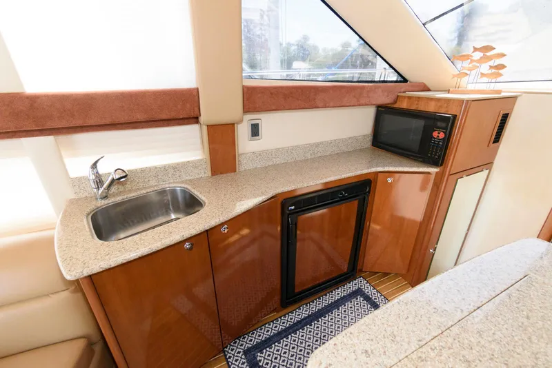 Slide: The Image of 2007 Meridian 341 Sedan yacht kitchen with sink, microwave, and compact fridge. - 15