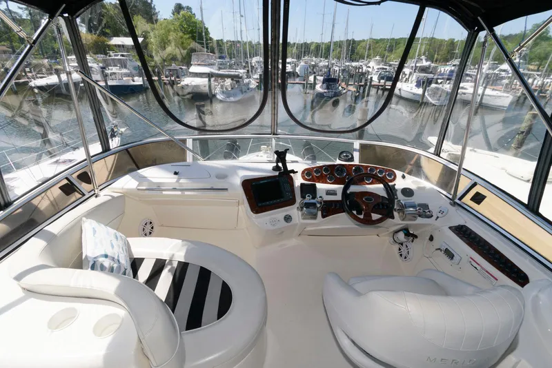 Slide: The Image of 2007 Meridian 341 Sedan yacht cockpit with marina view, featuring modern navigation equipment and seating. - 6