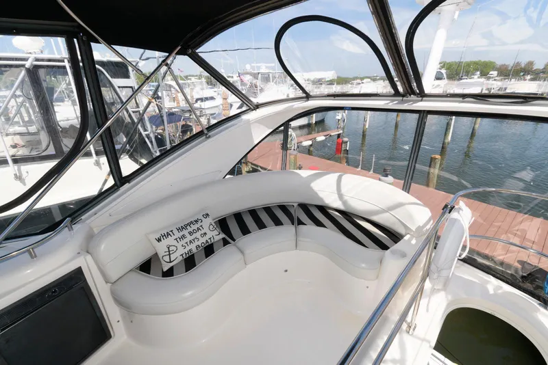 Slide: The Image of 2007 Meridian 341 Sedan yacht interior with curved seating and marina view. - 7