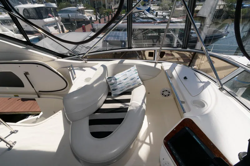 Slide: The Image of 2007 Meridian 341 Sedan yacht interior with cushioned seating and marina view. - 9