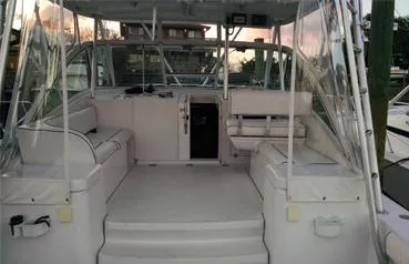 Slide: The Image of 2000 Luhrs 36 SX boat interior with spacious seating and clear canopy. - 4