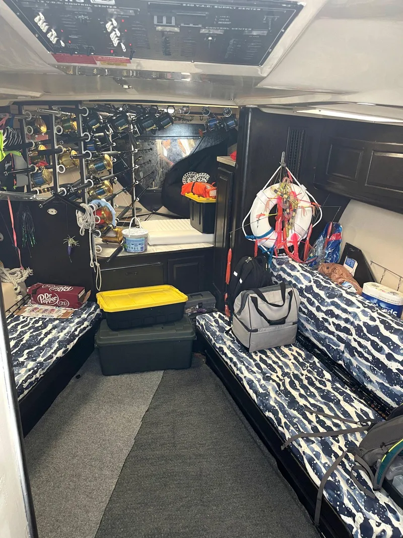 Slide: The Image of Interior of a 2000 Luhrs 36 SX boat with patterned seating and fishing gear. - 5