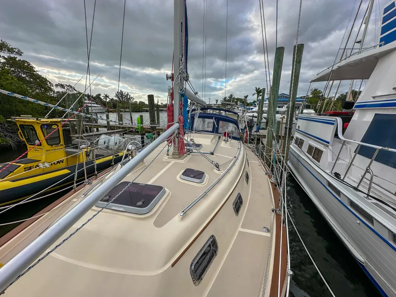 The Image of 2005 Island Packet 370 sailboat docked, surrounded by other boats under cloudy skies. - 0
