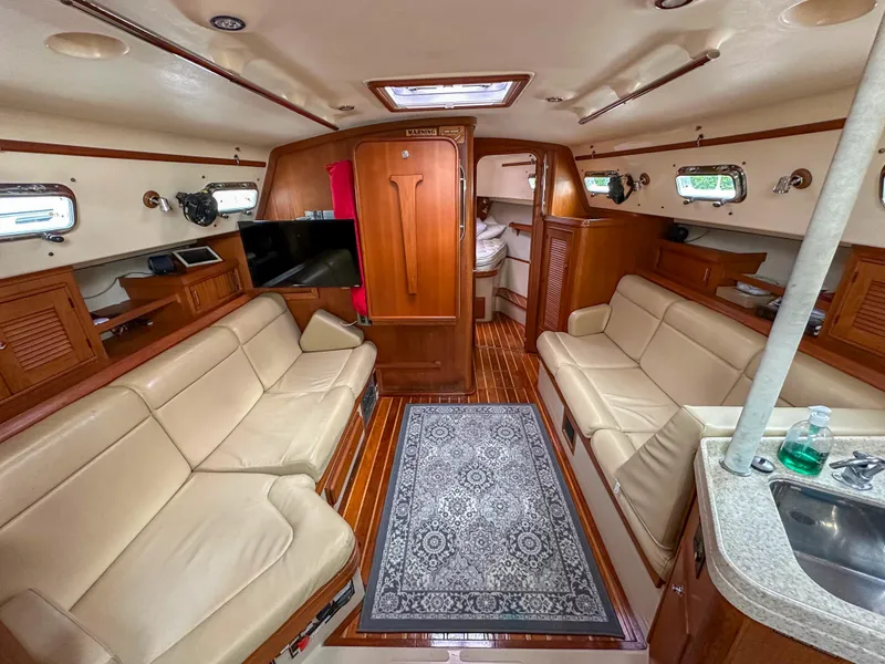 Slide: The Image of Interior of 2005 Island Packet 370 yacht with beige seating and wooden finishes. - 11