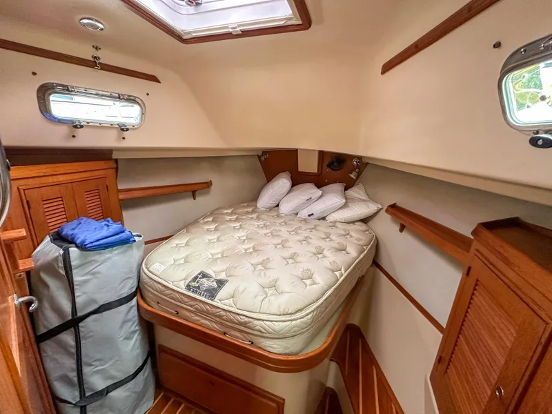 Slide: The Image of Cozy cabin interior of 2005 Island Packet 370 sailboat with bed and storage. - 12