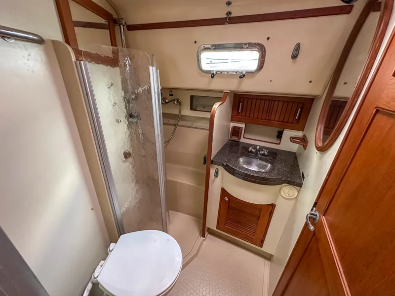 Slide: The Image of 2005 Island Packet 370 yacht bathroom with shower, sink, and toilet. - 13