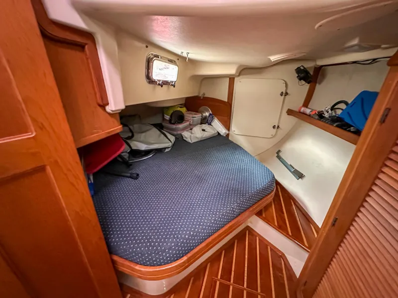 Slide: The Image of Cozy cabin interior of 2005 Island Packet 370 sailboat with wooden accents and storage. - 16