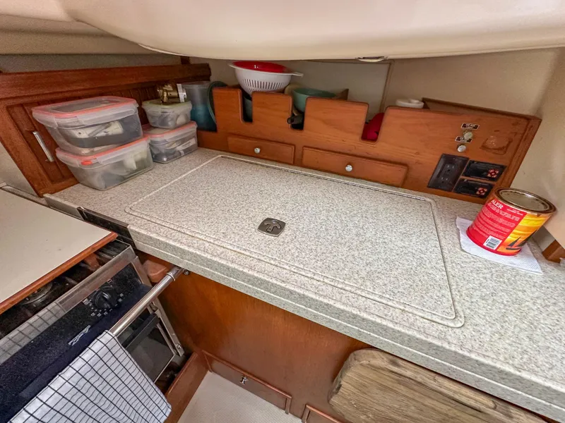 Slide: The Image of Interior of 2005 Island Packet 370 sailboat kitchen with storage and countertop. - 17
