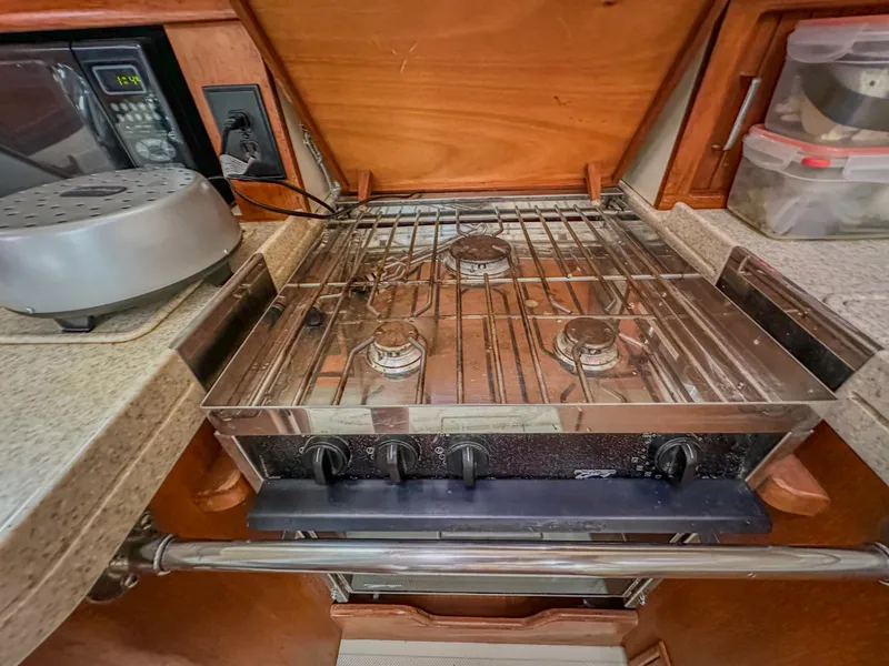 Slide: The Image of 2005 Island Packet 370 yacht kitchen with three-burner stove and countertop appliances. - 18