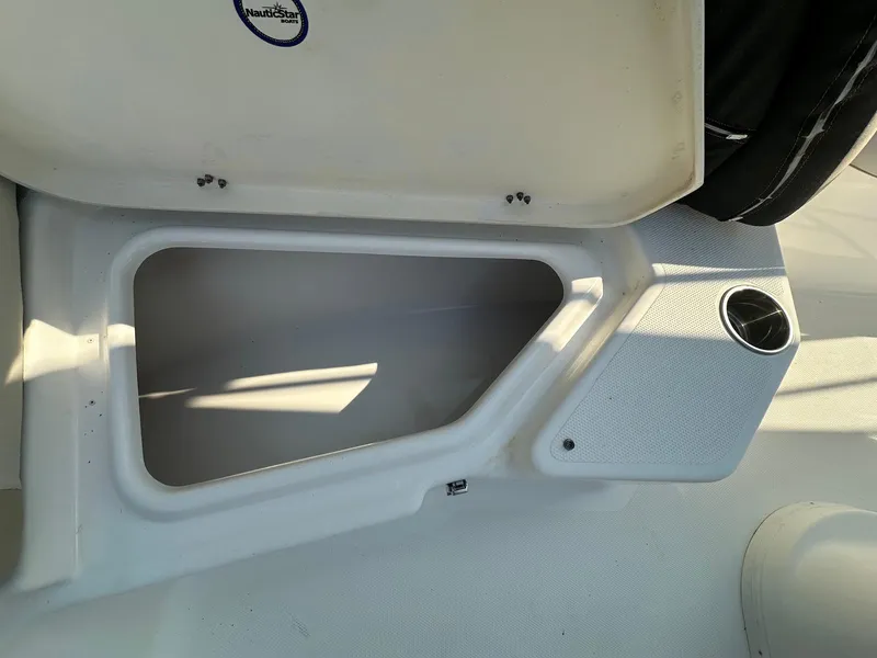 Slide: The Image of Open storage compartment on a 2021 NauticStar 211 Hybrid boat. - 14