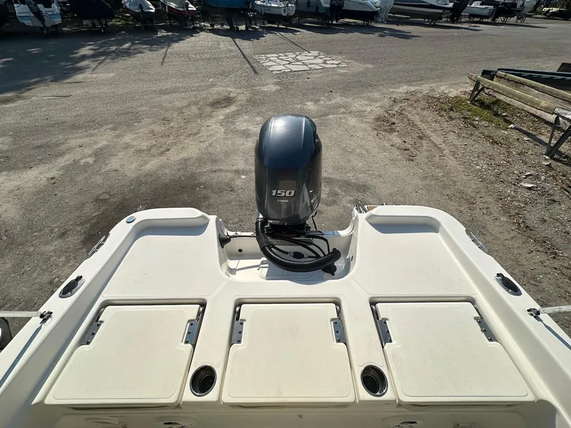 Slide: The Image of 2021 NauticStar 211 Hybrid boat with 150 HP engine, rear view. - 23