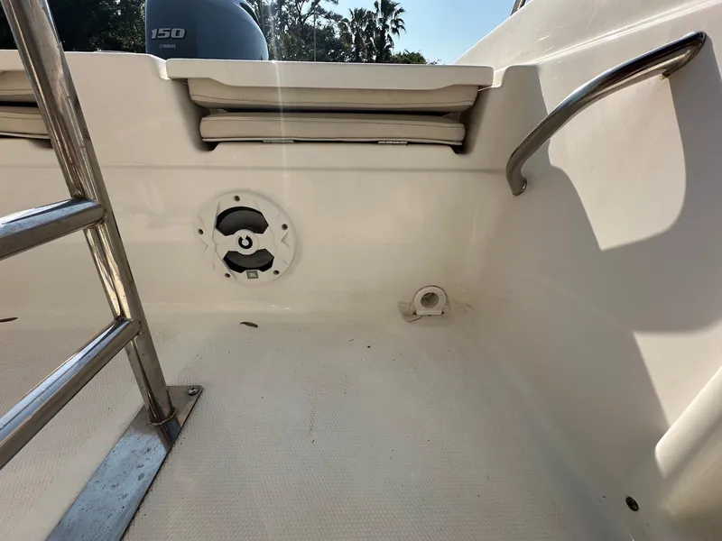 Slide: The Image of 2021 NauticStar 211 Hybrid boat interior with ladder and seating area. - 25