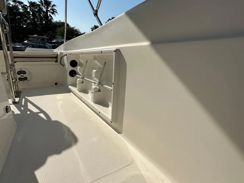 Slide: The Image of 2021 NauticStar 211 Hybrid boat interior with storage compartments and clean deck. - 28