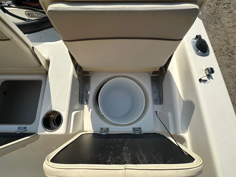 Slide: The Image of 2021 NauticStar 211 Hybrid boat interior with open storage compartments and seating. - 30