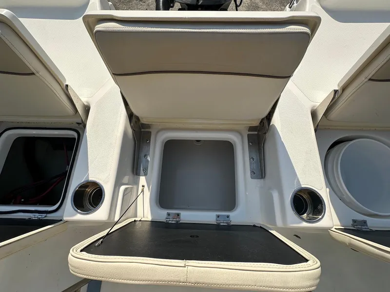 Slide: The Image of 2021 NauticStar 211 Hybrid boat interior with storage compartments and cup holders. - 31