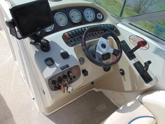Slide: The Image of 2001 Chaparral 280SSi boat dashboard with steering wheel and control panel. - 11
