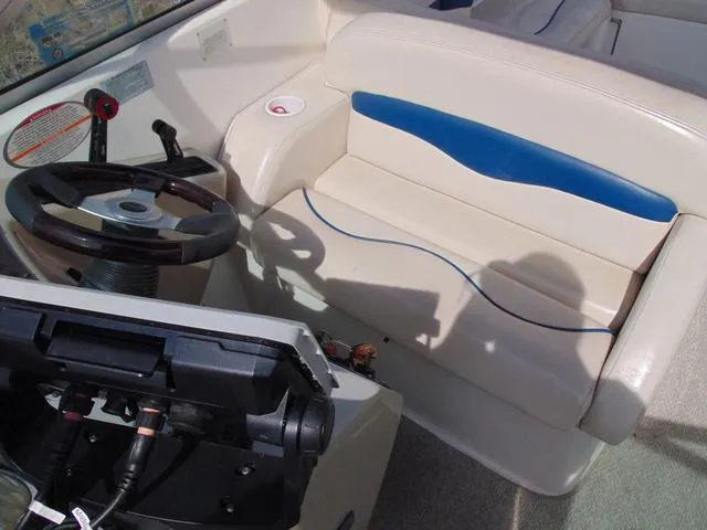 Slide: The Image of Interior of a 2001 Chaparral 280SSi boat, featuring steering wheel and seating. - 17