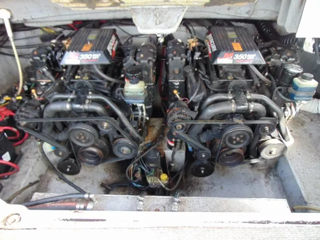 Slide: The Image of Twin engines in a 2001 Chaparral 280SSi boat, showcasing mechanical components and belts. - 19