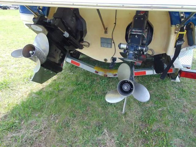 Slide: The Image of 2001 Chaparral 280SSi boat with dual propellers on a grassy surface. - 5