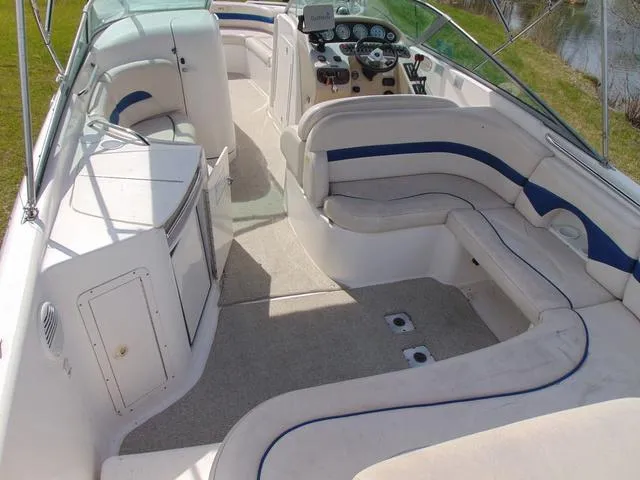 Slide: The Image of 2001 Chaparral 280SSi boat interior with white and blue seating, steering console, and open deck. - 7