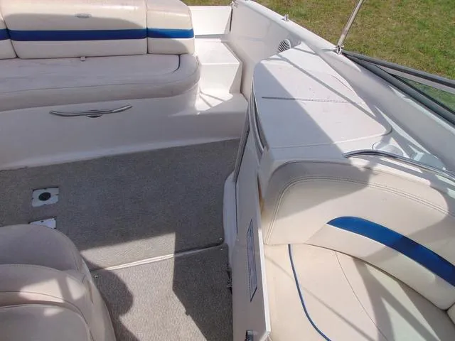 Slide: The Image of 2001 Chaparral 280SSi boat interior with white and blue seating, carpeted floor. - 9