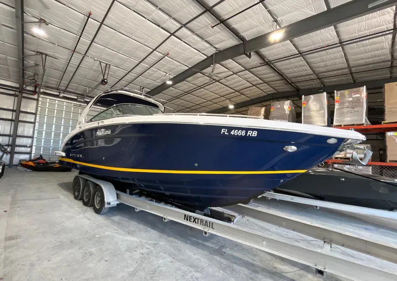 The Image of 2016 Regal 3200 Bowrider boat on trailer in storage facility. - 0