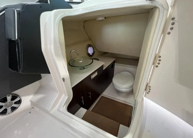 Slide: The Image of 2016 Regal 3200 Bowrider interior with sink, toilet, and storage. - 11