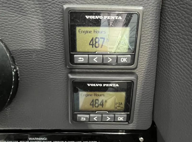 Slide: The Image of Volvo Penta engine hour meters showing 487 and 484 hours on Regal 3200 Bowrider. - 14