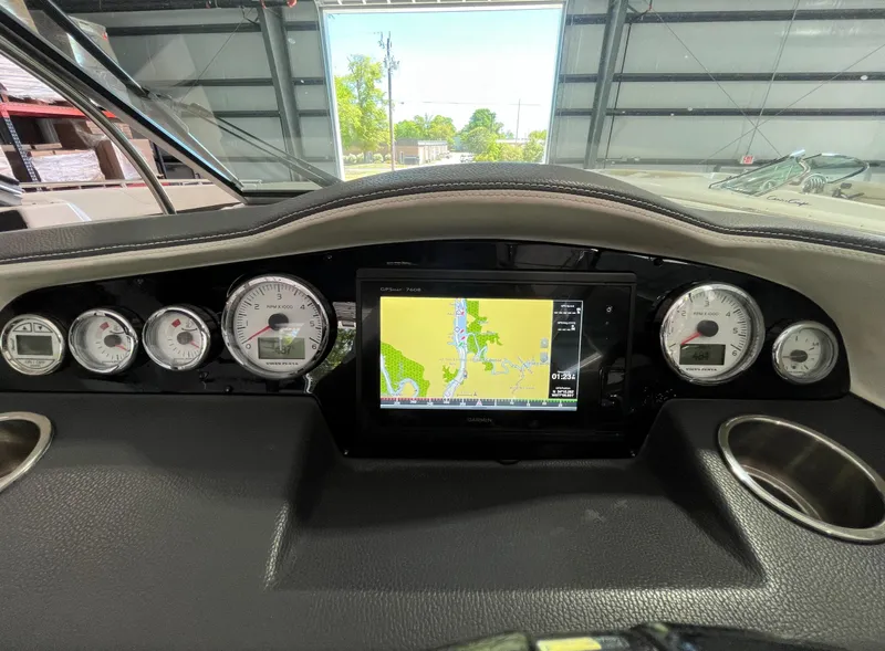 Slide: The Image of Dashboard of a 2016 Regal 3200 Bowrider with navigation display and gauges. - 15
