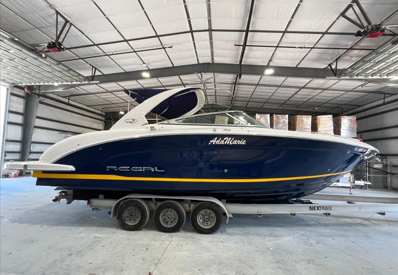 Slide: The Image of 2016 Regal 3200 Bowrider boat on trailer in indoor storage facility. - 2