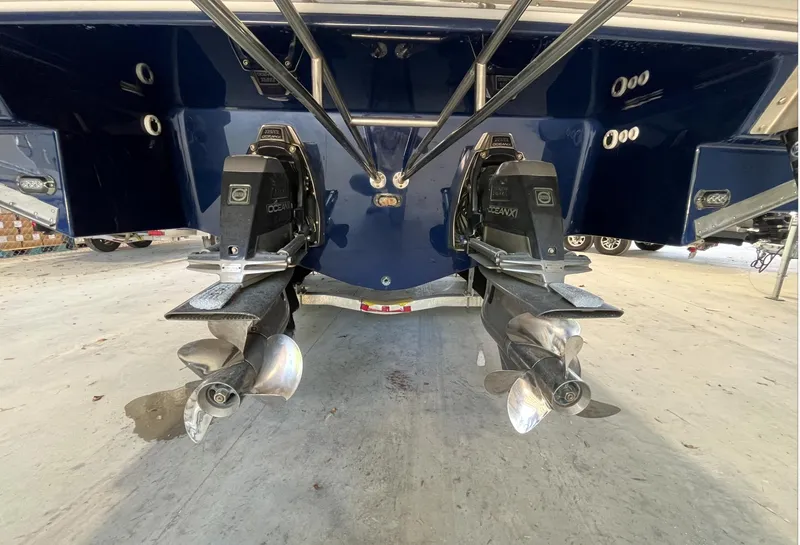 Slide: The Image of 2016 Regal 3200 Bowrider boat with dual propellers, rear view. - 3