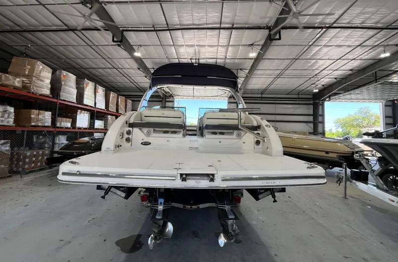 Slide: The Image of 2016 Regal 3200 Bowrider boat in a warehouse, rear view. - 4