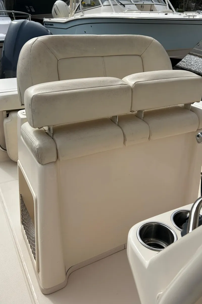 Slide: The Image of 2015 Grady-White Fisherman 257 boat dashboard with Garmin electronics and steering wheel. - 14