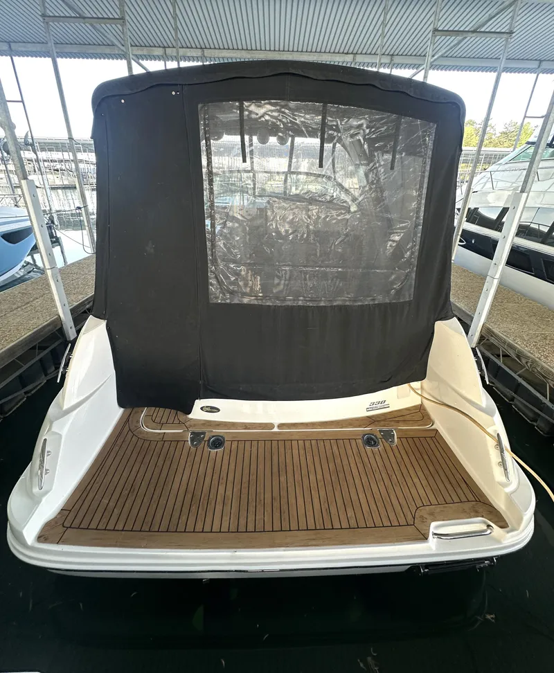 Slide: The Image of 2014 Sea Ray 330 Sundancer boat with covered deck, docked in marina. - 10