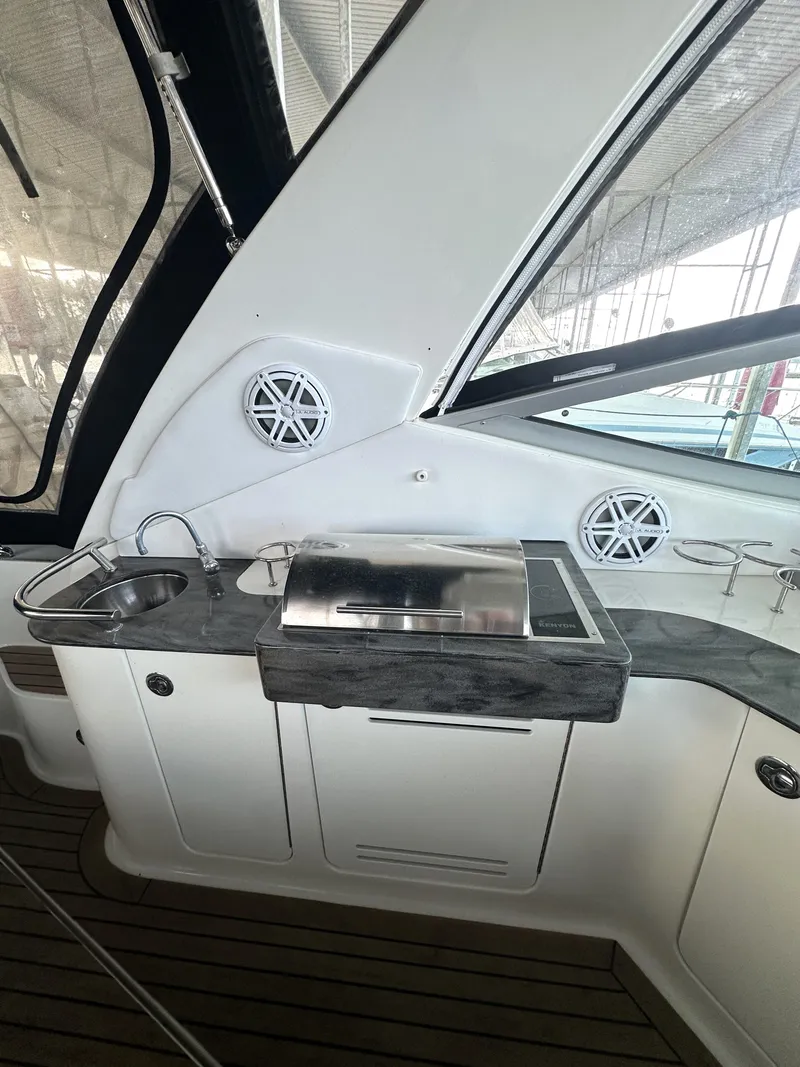 Slide: The Image of 2014 Sea Ray 330 Sundancer yacht interior with sink and grill station. - 16