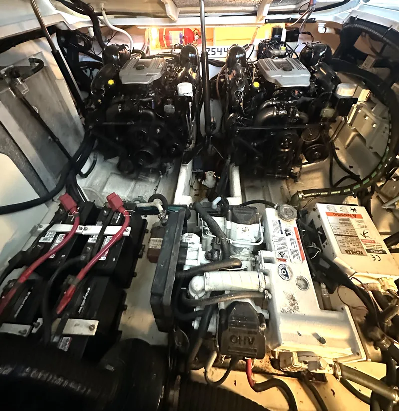 Slide: The Image of Engine compartment of a 2014 Sea Ray 330 Sundancer with dual engines and battery setup. - 26