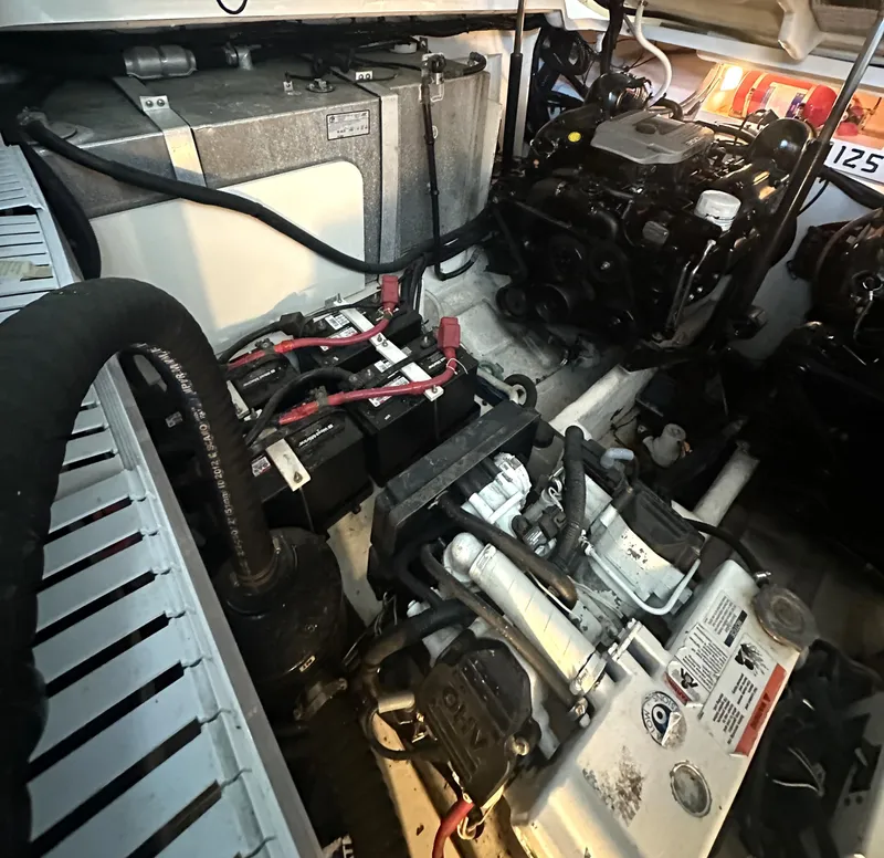 Slide: The Image of Engine compartment of a 2014 Sea Ray 330 Sundancer with visible components and wiring. - 27
