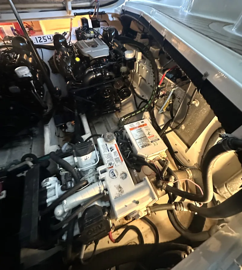 Slide: The Image of Engine compartment of a 2014 Sea Ray 330 Sundancer boat, showcasing mechanical components. - 28