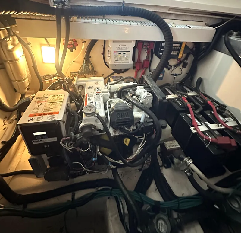 Slide: The Image of Engine compartment of a 2014 Sea Ray 330 Sundancer with visible wiring and components. - 29
