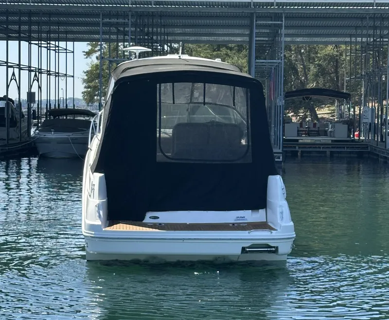 Slide: The Image of 2014 Sea Ray 330 Sundancer docked in a marina, rear view. - 9