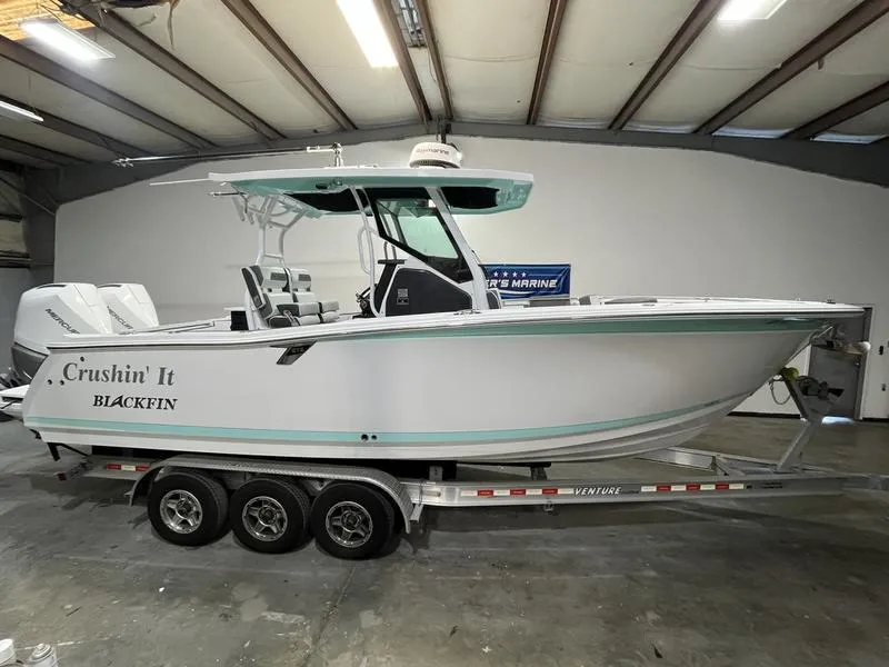 Slide: The Image of 2019 Blackfin 272 CC boat on trailer in indoor storage. - 0