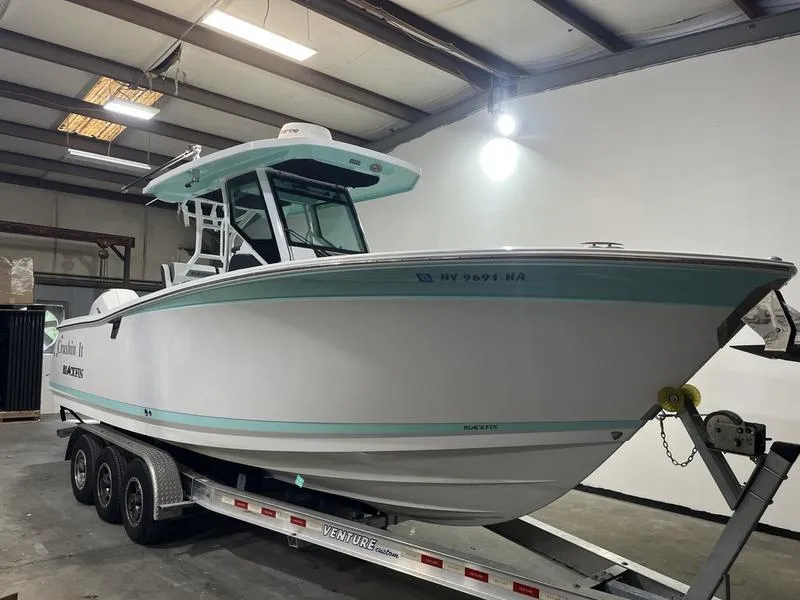 Slide: The Image of 2019 Blackfin 272 CC boat on trailer in indoor storage facility. - 1