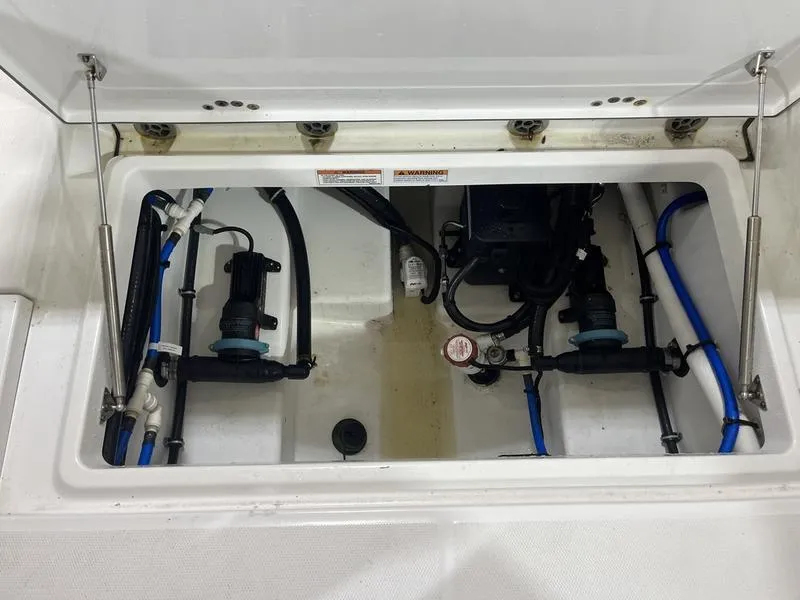Slide: The Image of 2019 Blackfin 272 CC boat compartment with visible wiring and components. - 10