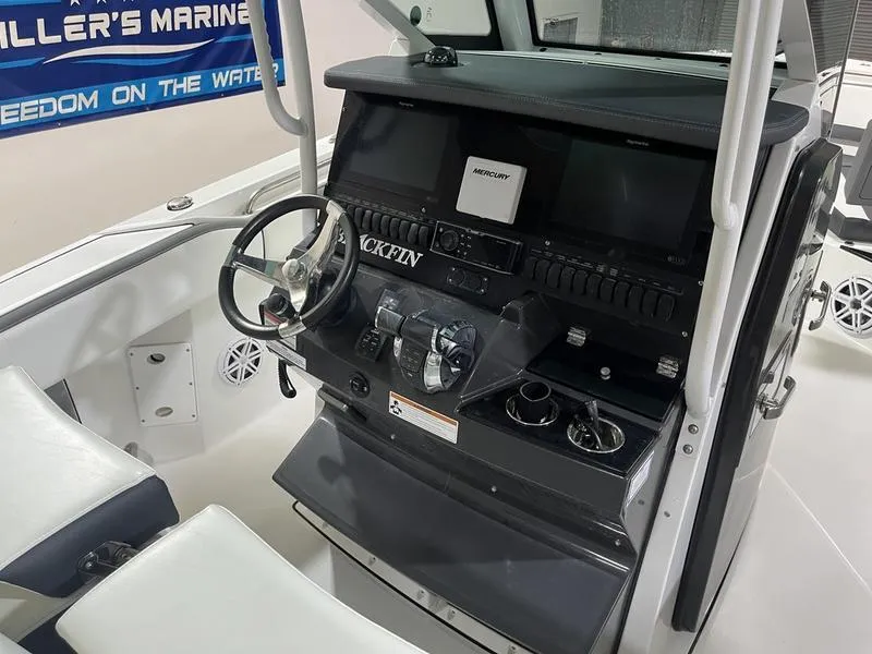 Slide: The Image of 2019 Blackfin 272 CC boat console with steering wheel and navigation controls. - 12