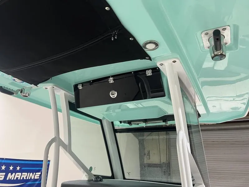 Slide: The Image of 2019 Blackfin 272 CC boat interior, featuring a sleek overhead storage compartment. - 14
