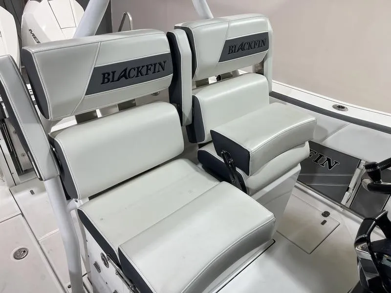 Slide: The Image of 2019 Blackfin 272 CC boat seating with white upholstery and Blackfin branding. - 15