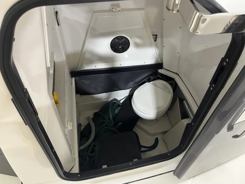 Slide: The Image of 2019 Blackfin 272 CC boat interior with compact marine toilet and storage space. - 17