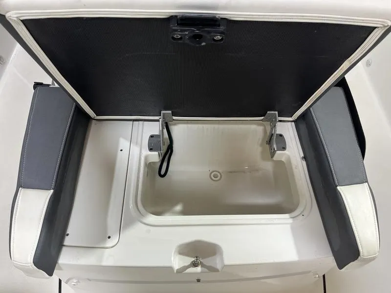 Slide: The Image of 2019 Blackfin 272 CC boat storage compartment with open lid and cushioned sides. - 19