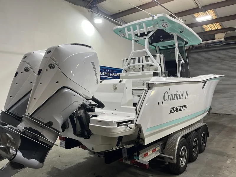 Slide: The Image of 2019 Blackfin 272 CC boat with twin engines on a trailer in a warehouse. - 4
